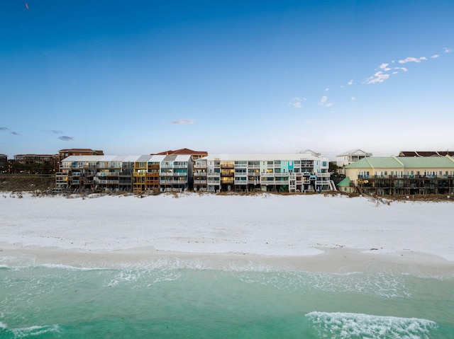 bird's eye view with a water view and a beach view