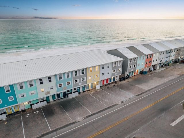 bird's eye view with a water view and a beach view