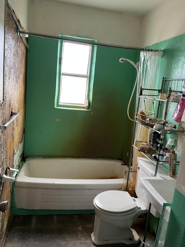 bathroom featuring concrete flooring, shower / bathing tub combination, and toilet