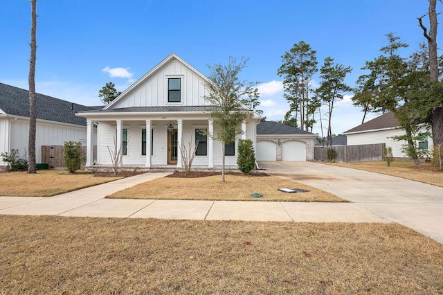 view of front of home featuring a garage, a front lawn, and a porch