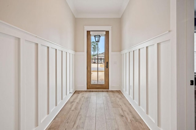 doorway to outside featuring light hardwood / wood-style flooring and ornamental molding