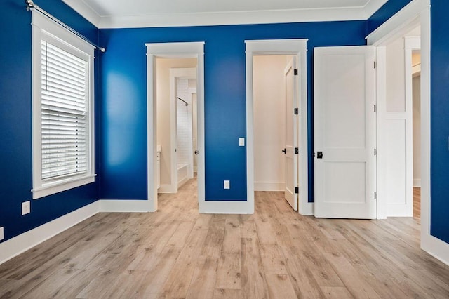 unfurnished bedroom featuring ornamental molding and light wood-type flooring