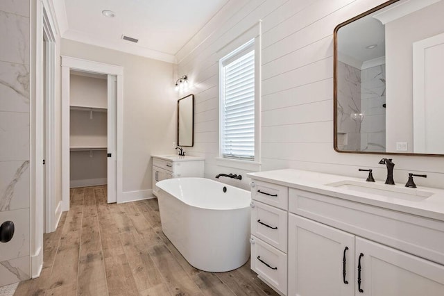 bathroom featuring vanity, crown molding, shower with separate bathtub, and hardwood / wood-style flooring