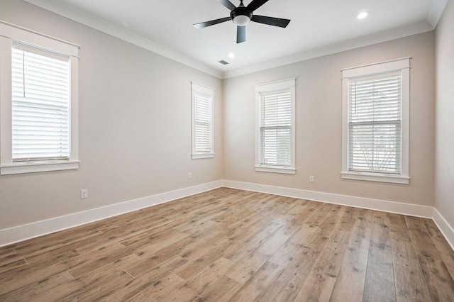 spare room with crown molding, light hardwood / wood-style flooring, and ceiling fan