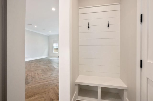 mudroom with parquet floors and ornamental molding