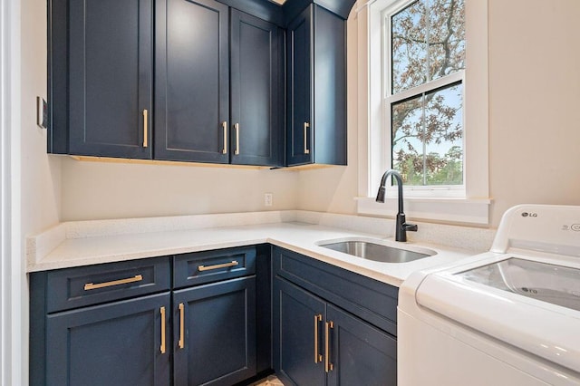 clothes washing area featuring sink and cabinets