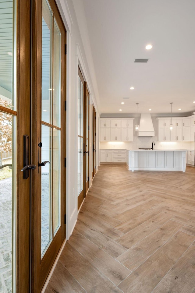 corridor with light parquet floors