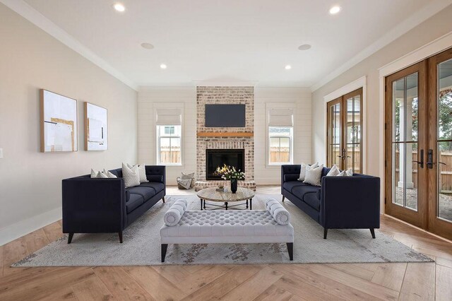 living room with light hardwood / wood-style flooring, ornamental molding, and french doors