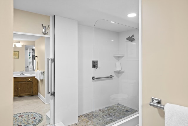 full bath with a stall shower, tile patterned flooring, and vanity