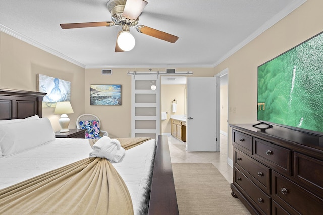 bedroom with light tile patterned floors, a barn door, visible vents, ensuite bath, and crown molding