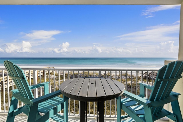 balcony with a water view and a beach view