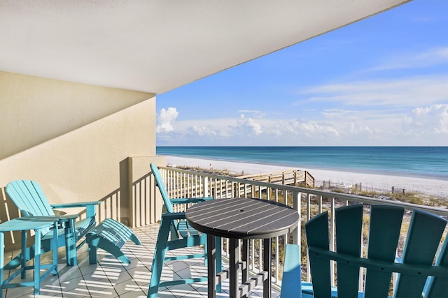 balcony featuring a water view and a beach view