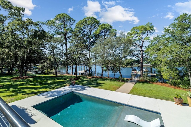 outdoor pool featuring a water view and a yard