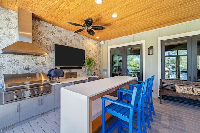 wooden deck featuring ceiling fan, grilling area, exterior kitchen, french doors, and a sink