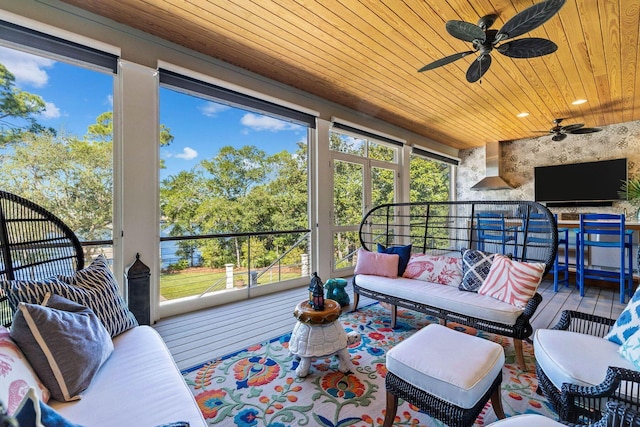 sunroom featuring wooden ceiling and ceiling fan