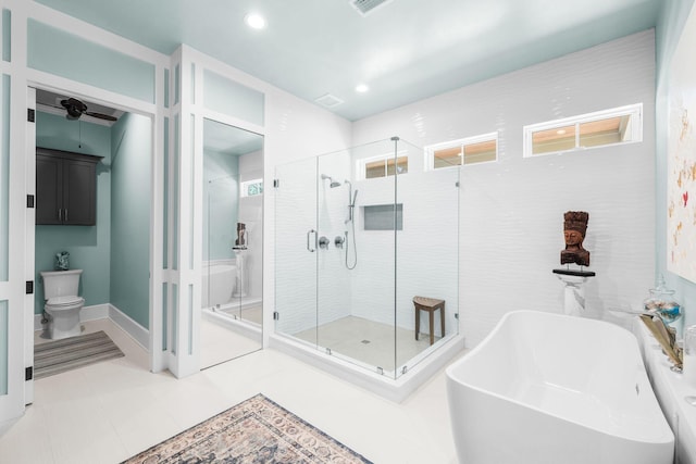 bathroom with visible vents, toilet, a freestanding bath, a shower stall, and recessed lighting