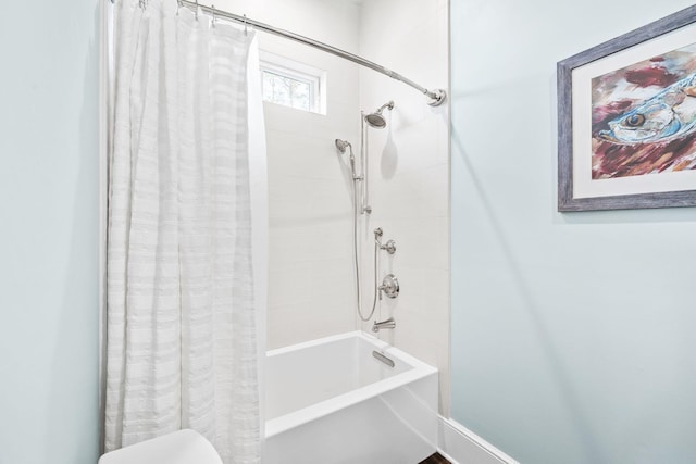 bathroom with shower / bath combination with curtain and toilet