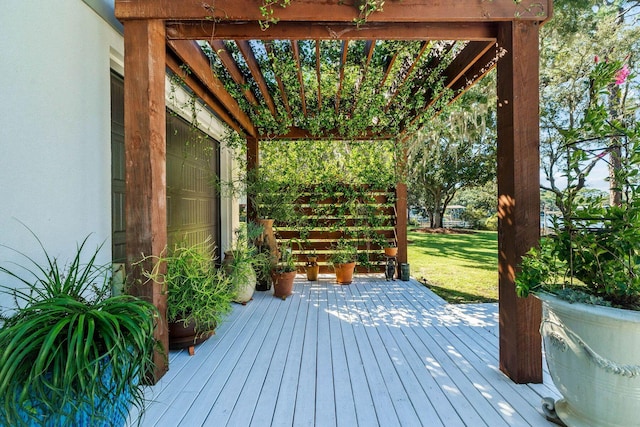 wooden deck featuring a lawn and a pergola