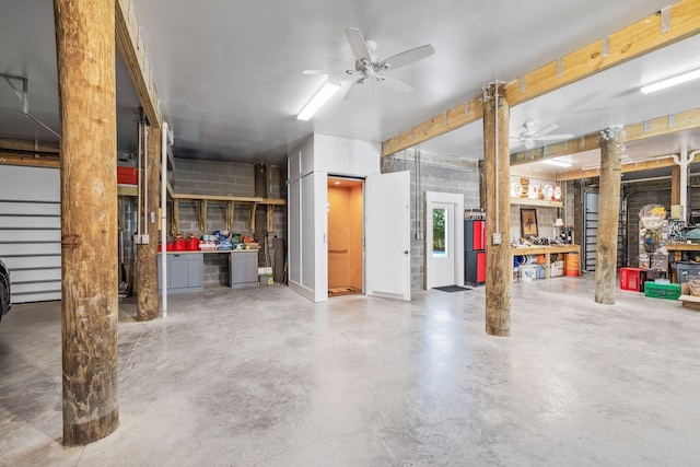 garage with ceiling fan and a workshop area