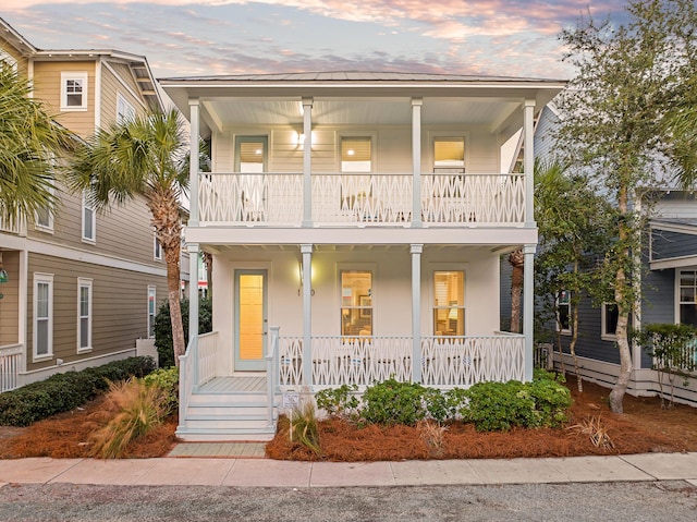 view of front of home featuring a balcony and covered porch