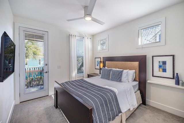 bedroom featuring light carpet, access to outside, and ceiling fan