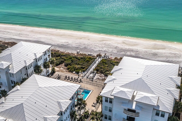 drone / aerial view featuring a water view and a beach view