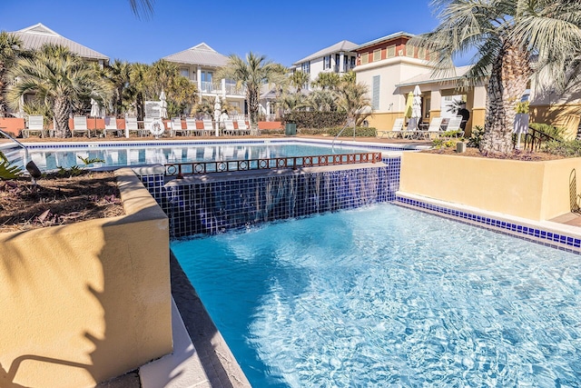 view of swimming pool featuring pool water feature