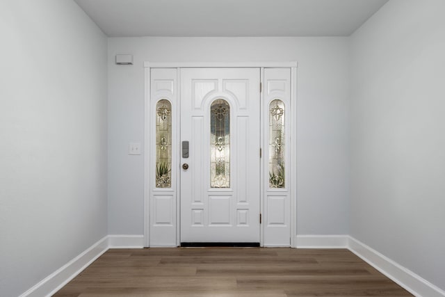 entryway featuring baseboards and wood finished floors