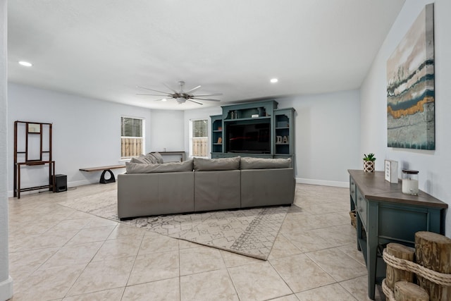 living area featuring light tile patterned floors, recessed lighting, a ceiling fan, and baseboards