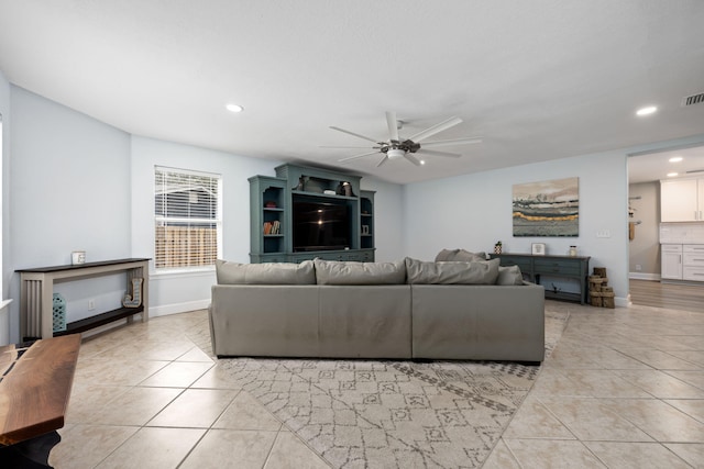 living room featuring recessed lighting, baseboards, a ceiling fan, and light tile patterned flooring