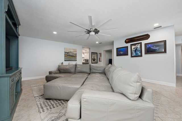 living area with light tile patterned floors, baseboards, visible vents, and recessed lighting