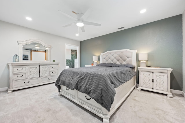 bedroom featuring baseboards, visible vents, and light colored carpet