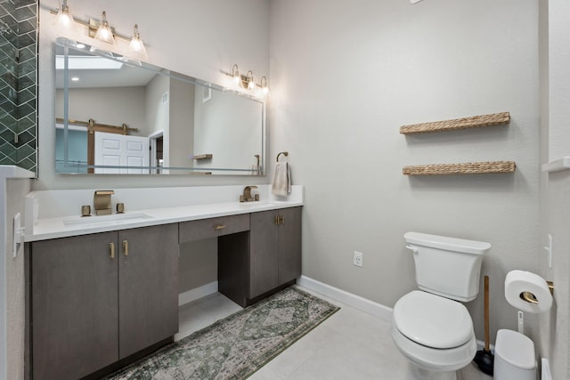 full bathroom featuring toilet, double vanity, baseboards, and a sink