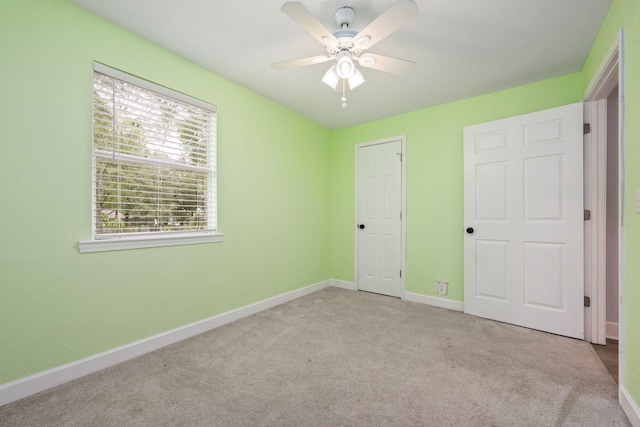 unfurnished bedroom with carpet flooring, ceiling fan, and baseboards