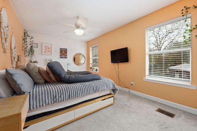 bedroom with a ceiling fan, carpet, visible vents, and baseboards