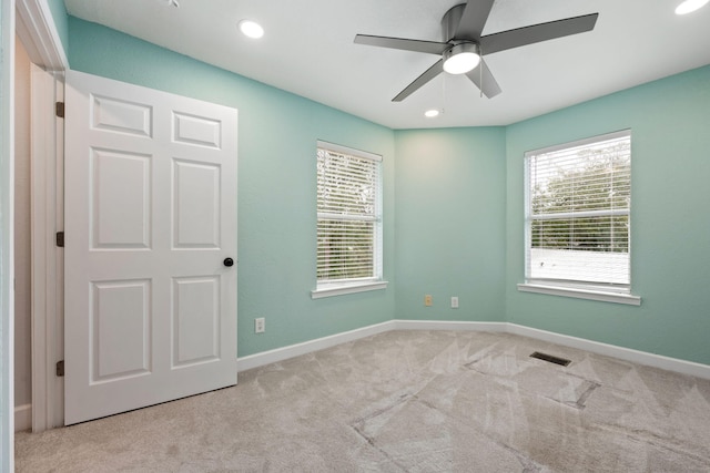 unfurnished room featuring a ceiling fan, carpet, visible vents, and baseboards