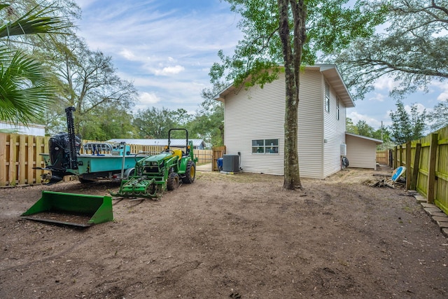 exterior space featuring cooling unit and fence