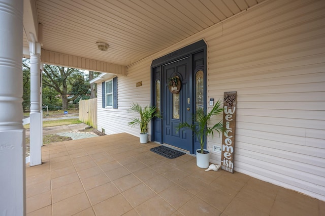 view of exterior entry with a porch