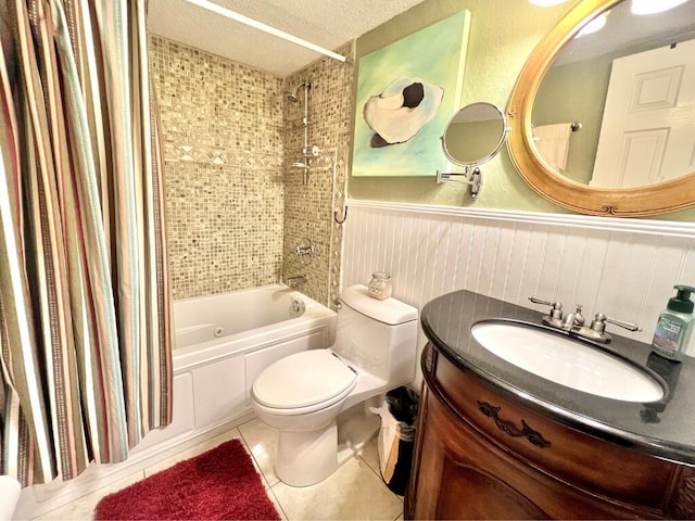 full bathroom featuring shower / tub combo with curtain, vanity, a textured ceiling, tile patterned floors, and toilet