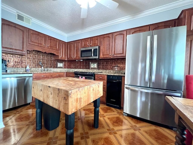 kitchen with sink, crown molding, a textured ceiling, appliances with stainless steel finishes, and backsplash