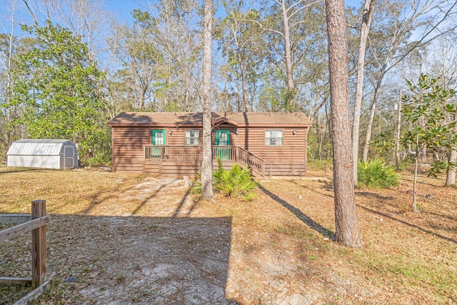 view of front of house with a shed and an outbuilding