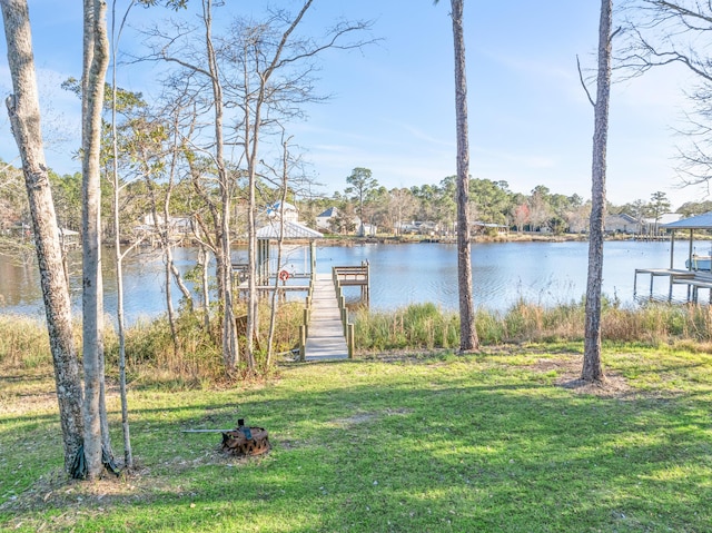 view of yard featuring a water view and a boat dock