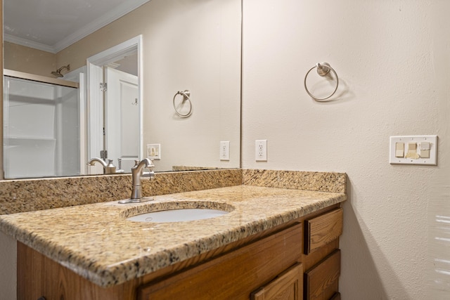 bathroom featuring a shower, ornamental molding, and vanity