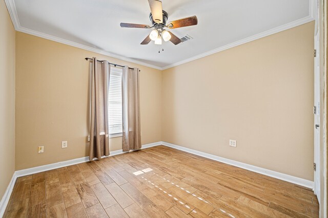 unfurnished room with wood finished floors, visible vents, baseboards, a ceiling fan, and crown molding