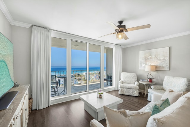 living area featuring ceiling fan, a water view, dark wood-style floors, a wall of windows, and crown molding