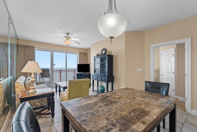 tiled dining room with ceiling fan