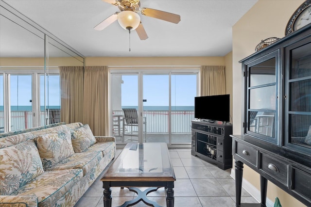 tiled living room featuring ceiling fan