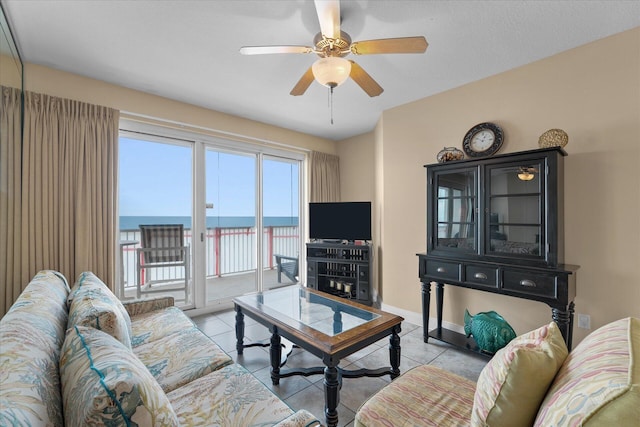 tiled living room featuring ceiling fan