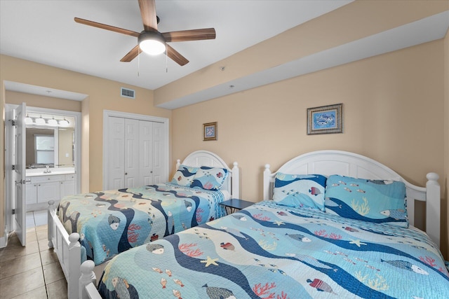 tiled bedroom featuring connected bathroom, sink, a closet, and ceiling fan