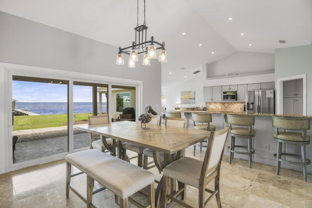 dining space with high vaulted ceiling, recessed lighting, a water view, and visible vents